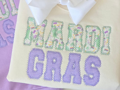 Embroidered baby blanket with 'Girl' and baby elements on a purple background