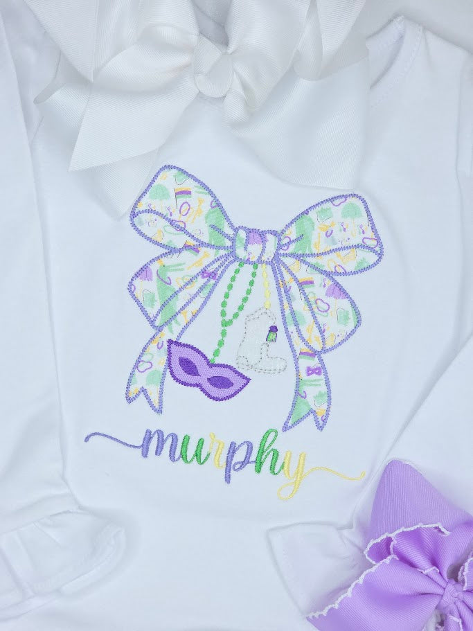 White baby outfit with colorful bow and mask design, featuring the name 'murphy'.