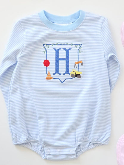 Personalized boys blue stripe construction bubble romper with embroidered monogram and construction truck design