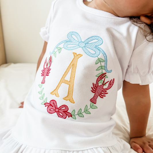 Personalized girls crawfish shirt with embroidered initial, bows and floral crest